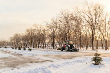 tractor cleans snow in the park, cleaning equipment
