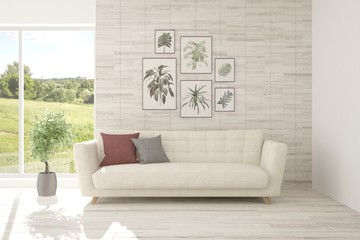 Idea of white room with sofa and summer landscape in window. Scandinavian interior design. 3D illustration