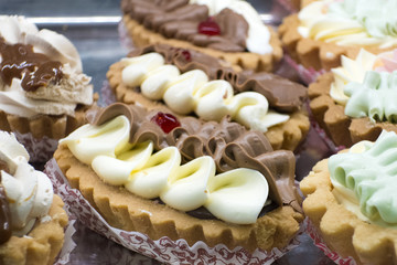 Obraz na płótnie Canvas Appetizing different cakes made with cream close-up.