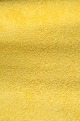 vertical close up on a yellow terry cloth towel, background