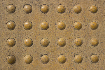 Tile in metro. Texture. With round protrusions .  Relief tactile tiles.