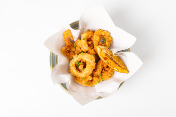 Fried crispy squid rings ( caramari ) Sprinkle sesame seeds top view in a paper on white backgruond