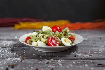 pasta from green spinach with mozzarella, greens and French mustard, quail eggs and cherry tomatoes...