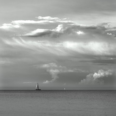 Seascape with a sailboat - evening shore in Orlowo beach in Gdynia, Tricity, Poland