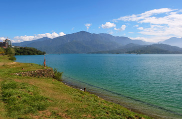 View of aqua lake with big mountain and blue sky