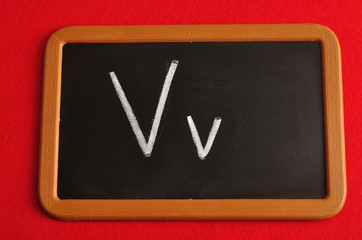 A black board with the alphabet letter V in a capital and small letter