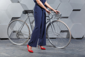 Fashionably dressed woman with bike