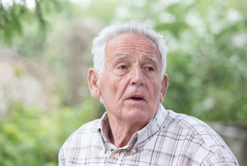 Depressed old man in park