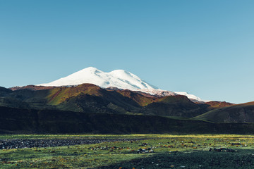 Elbrus, Green Hills And Meadow At Sunny Day. Elbrus Region, Northen Caucasus, Russia