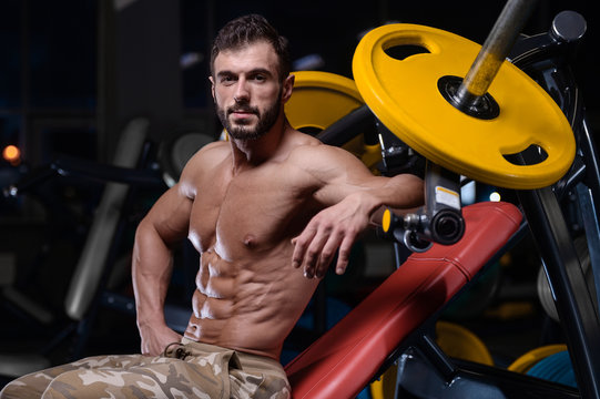 sexy strong bodybuilder athletic men pumping up muscles with dumbbells