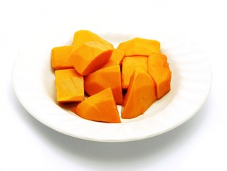 Cut papaya on white plate; white background. Deliciously sweet high fibre fruit; rich sources of antioxidant nutrients (carotenes, flavonoids, B and C vitamins, folate, minerals, etc.).