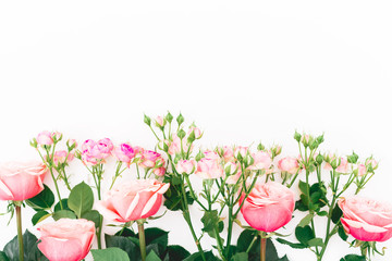 Flowers roses, branches and leaves on white background. Flat lay, Top view. Roses flower texture