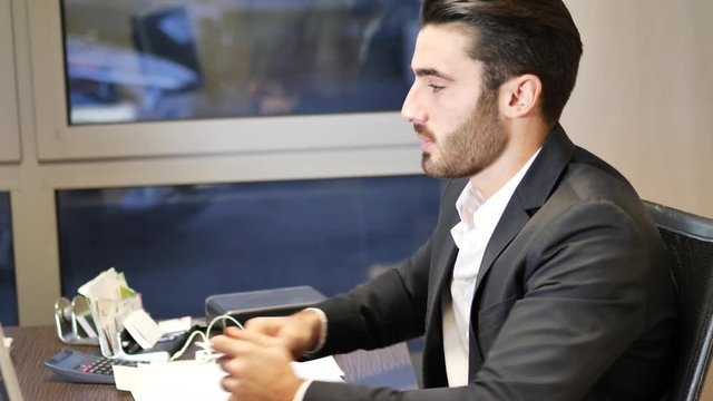 Businessman paying cash money to other man, colleague, collaborator, client or employee