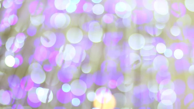 Blurred purple glitter vintage Blinking christmas lights LED bulbs motion, Close up of big bokeh lights loopable background, Defocused or Abstract Neon lights.