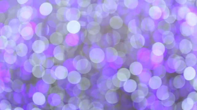 Blurred purple glitter vintage Blinking christmas lights LED bulbs motion, Close up of big bokeh lights loopable background, Defocused or Abstract Neon lights.