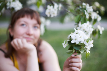 Spring. Portrait of a young girl. White flowers of an apple tree