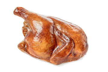 half a delicious smoked chicken in a plastic shell on white background