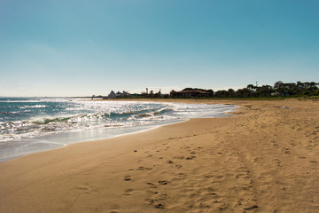 Sunny day in a curving beach with a great sand in Cyprus