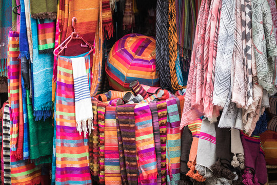 Selection of colorfu clothes on a traditional Moroccan market (souk) in Marrakech, Morocco