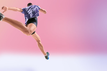 The studio shot of high jump athlete is in action