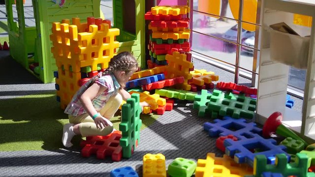 Preschool girl Playing Plastic Designer.