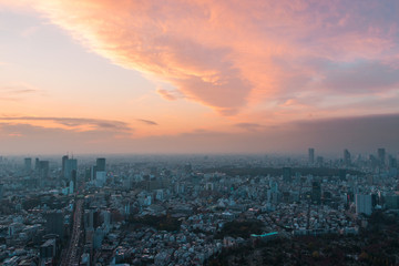 Naklejka na ściany i meble Tokyo city view under cloudy colorful sunset.