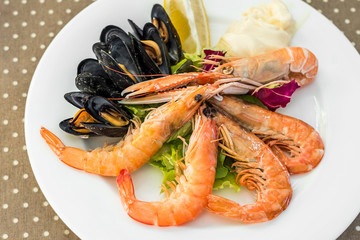 Tasty seafood on plate on table close-up, Siurana, Catalunya, Spain.