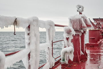 Obraz na płótnie Canvas Ship's details during heavy icing f merchant ship while navigating in extremely cold weather in north seas