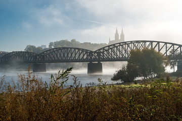 Bridge and church in fog in Prague