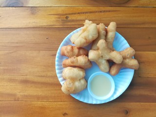 deep-fried doughstick, a kind of Chinese flour sweetmeat and sweetened condensed milk in white dish. Picture with copy space.