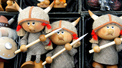 Funny cute vikings, Norwegian wooden souvenirs, horned helmet on the head, fairy tale scandinavian figures, Bergen market, Norway