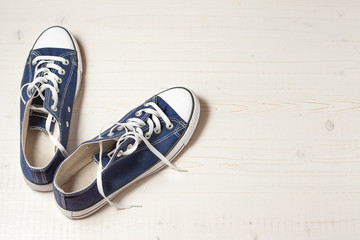 New sneakers on a white wooden background.