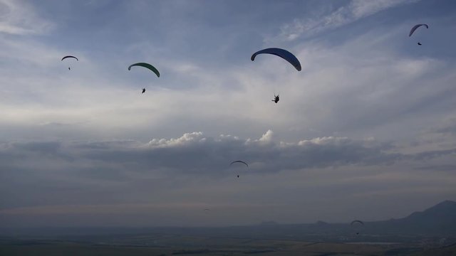 Paragliders in the deep blue sky