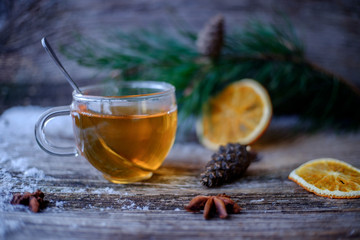 tea glass Cup on a wooden table with pine branches
