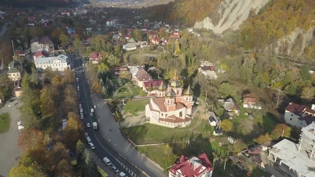 Flying over carpathian city Yaremche and orthodox church , Ukraine