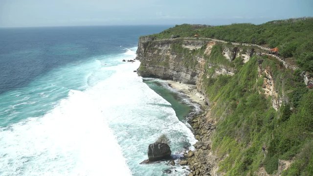 Uluwatu stone cliffs, ocean waves. Aerial top view. Bali, Indonesia