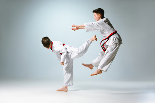 Studio shot of two of kids training karate martial arts