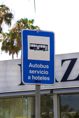 A bus stop sign with a reflective surface for complimentary hotel buses in Playa de Las Americas in Teneriffe