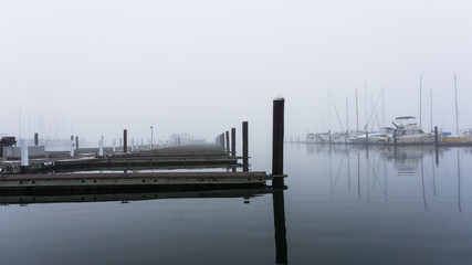 Obraz premium Diminishing view of docks on a misty morning - landscape view