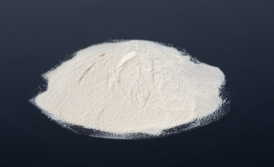 Protein powder on black background.