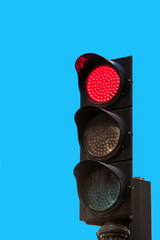 Traffic signal isolated on blue background, Madrid, Spain. Copy space for text. Vertical.