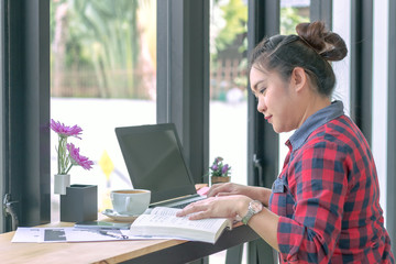 Close Up businessmen working at a coffee shop with a document with a smartphone and a laptop computer Vintage effect.