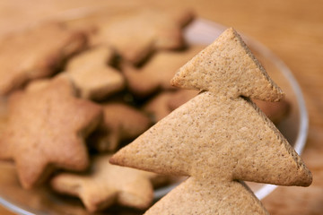 Gingerbread Cookie. Shape Christmas tree. Brown background