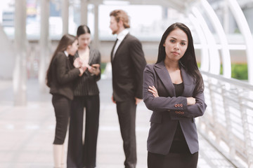 Confident looking mixed race business woman posing arm cross.