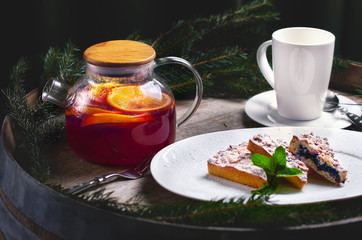 Christmas composition. Traditional Christmas dessert. Homemade cake with fruits and fir brunches. New Year. Selective focus