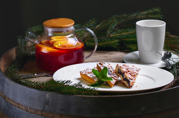 Christmas composition. Traditional Christmas dessert. Homemade cake with fruits and fir brunches. New Year. Selective focus