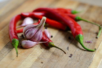 Garlic and pepper on a wooden background