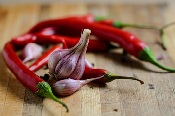 Garlic and pepper on a wooden background