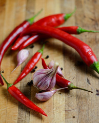 Garlic and pepper on a wooden background