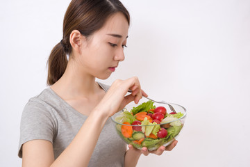 Diet. Beautiful Young Woman Eating Vegetable Salad